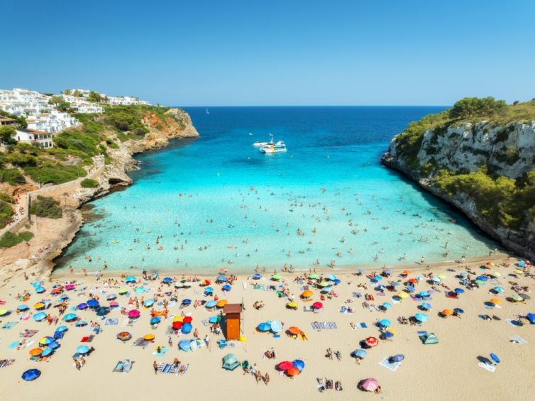 Aerial,View,Of,Colorful,Umbrellas,On,Crowded,Sandy,Beach,,Boats,